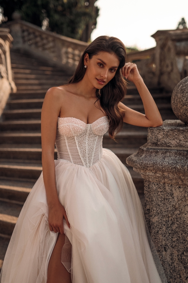 a classic princess gown with a beaded lace-up corset and a layered tulle skirt