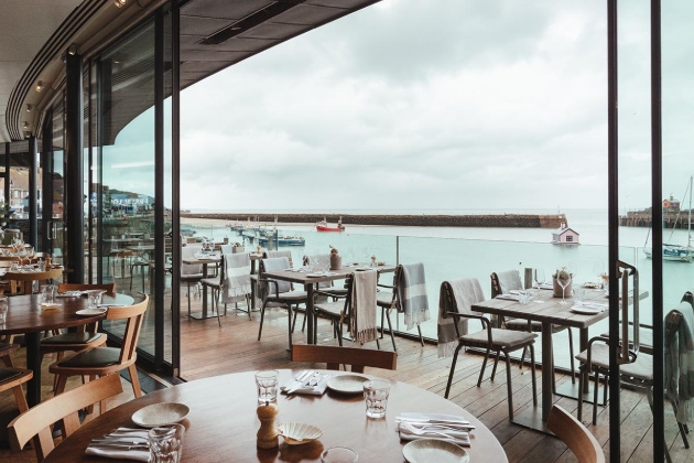 tables and chairs with a seaside view 