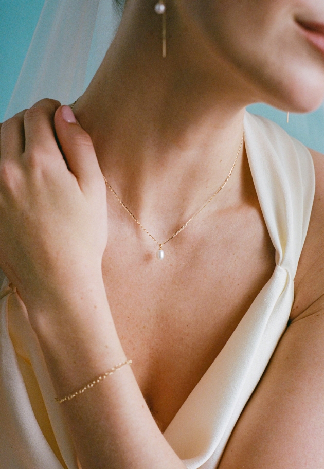 gold and pearl jewellery on a model